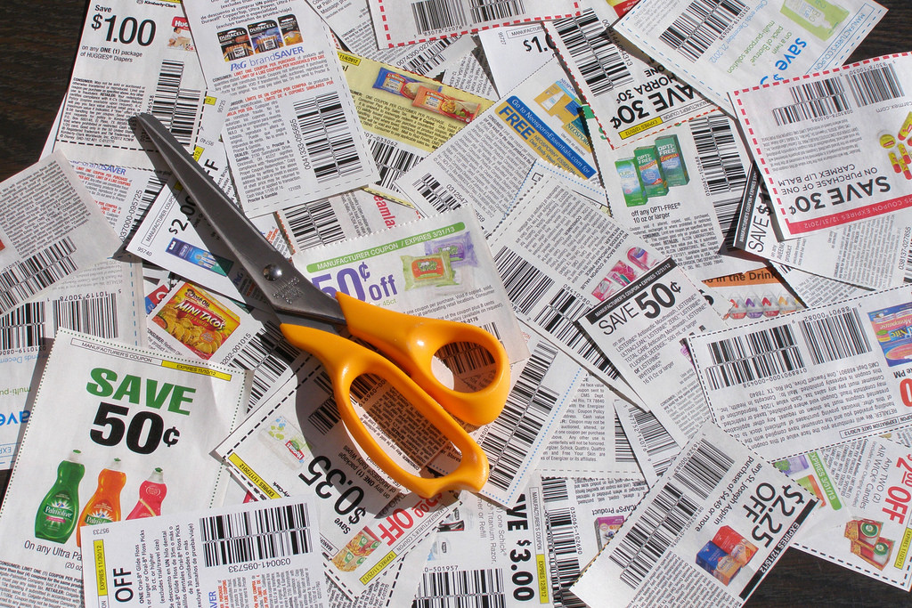 Pair of scissors laying on spread newspapers
