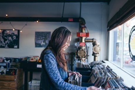 Asian woman going through music records