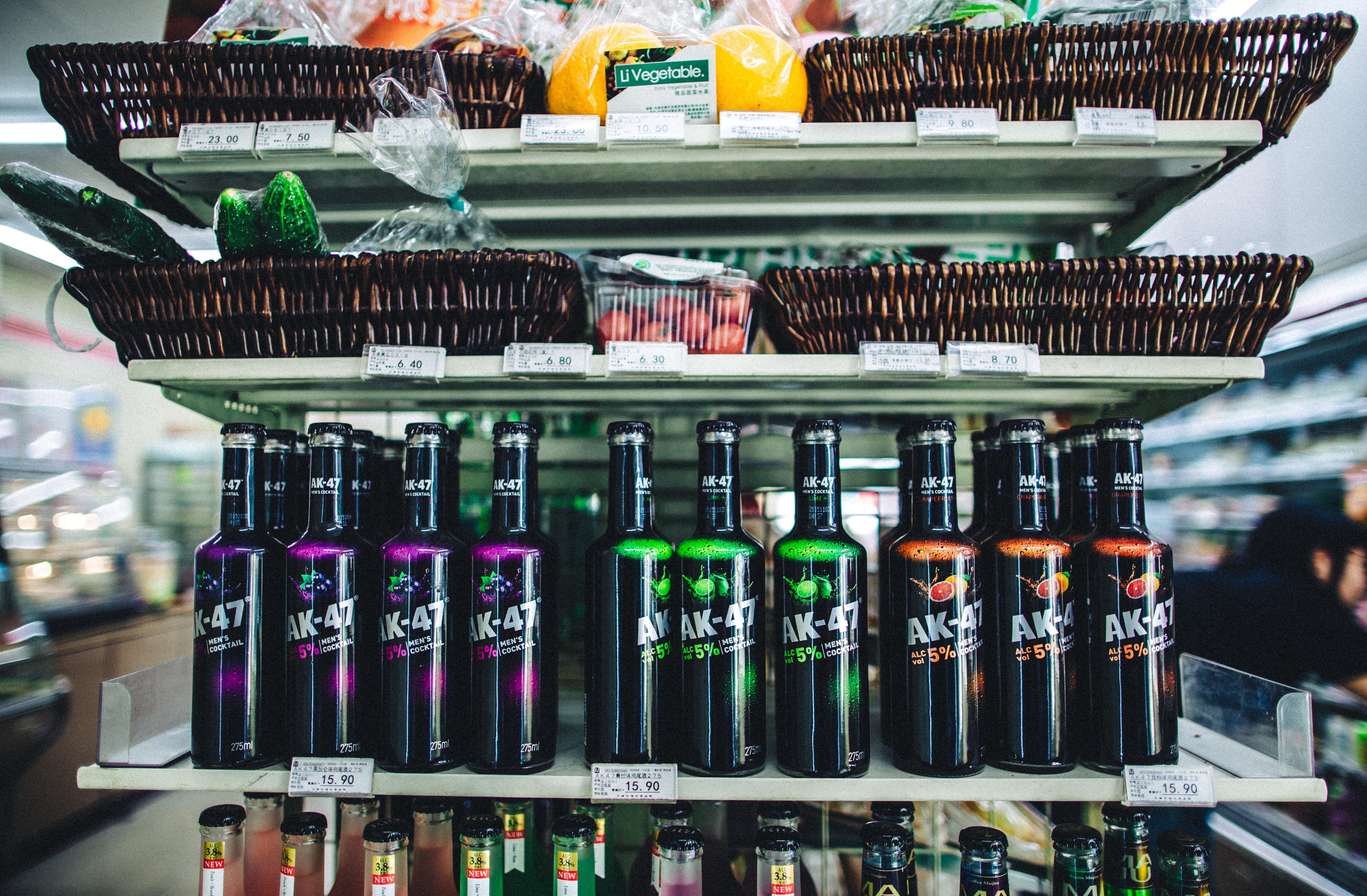 Supermarket shelf of beverage bottles and fruit baskets