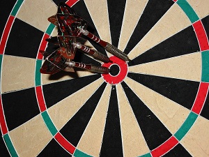 Dartboard with all darts in the centre